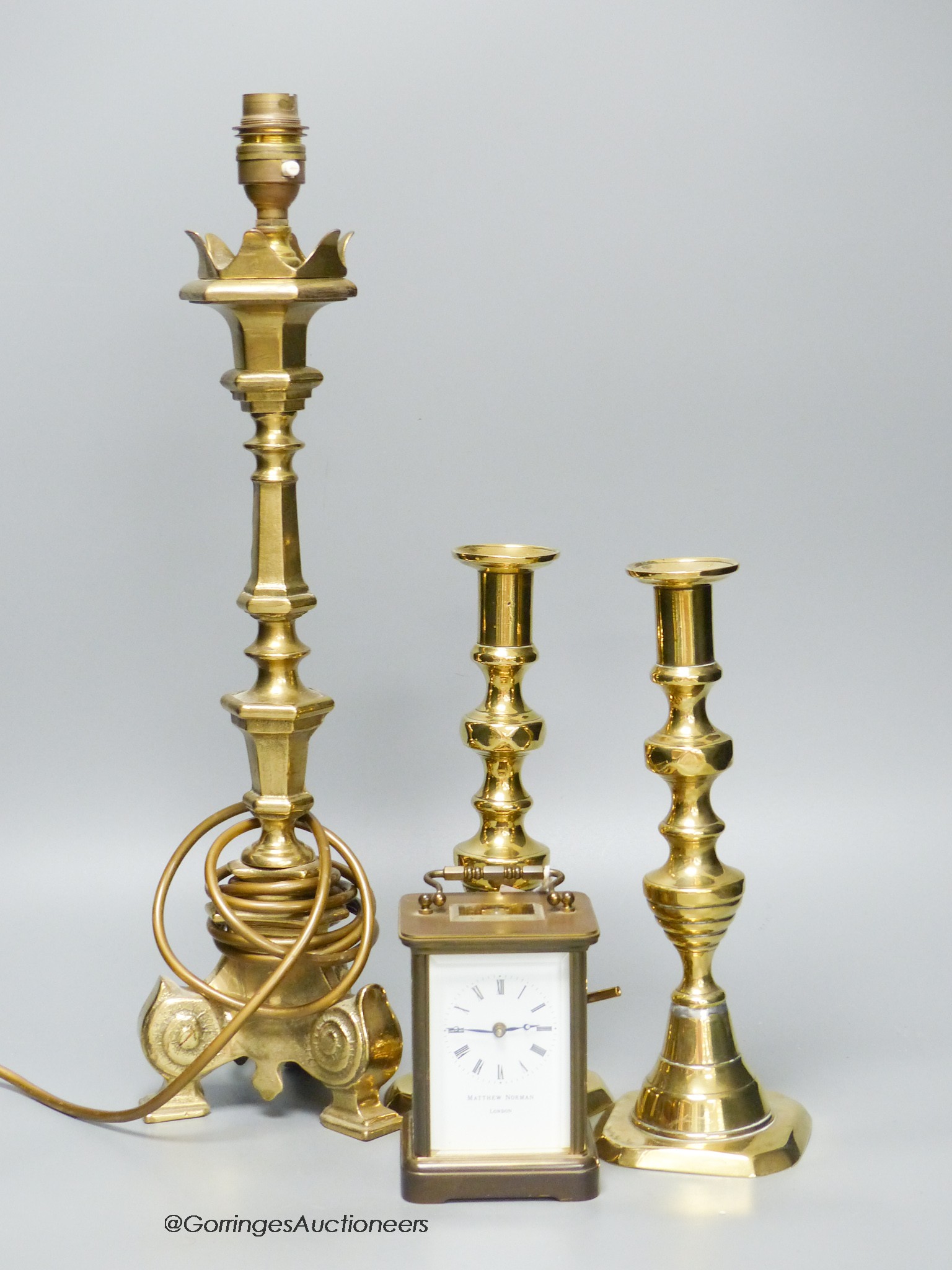 A Matthew Norman brass carriage clock, No.1754 together with a pair of brass candlesticks and a table lamp